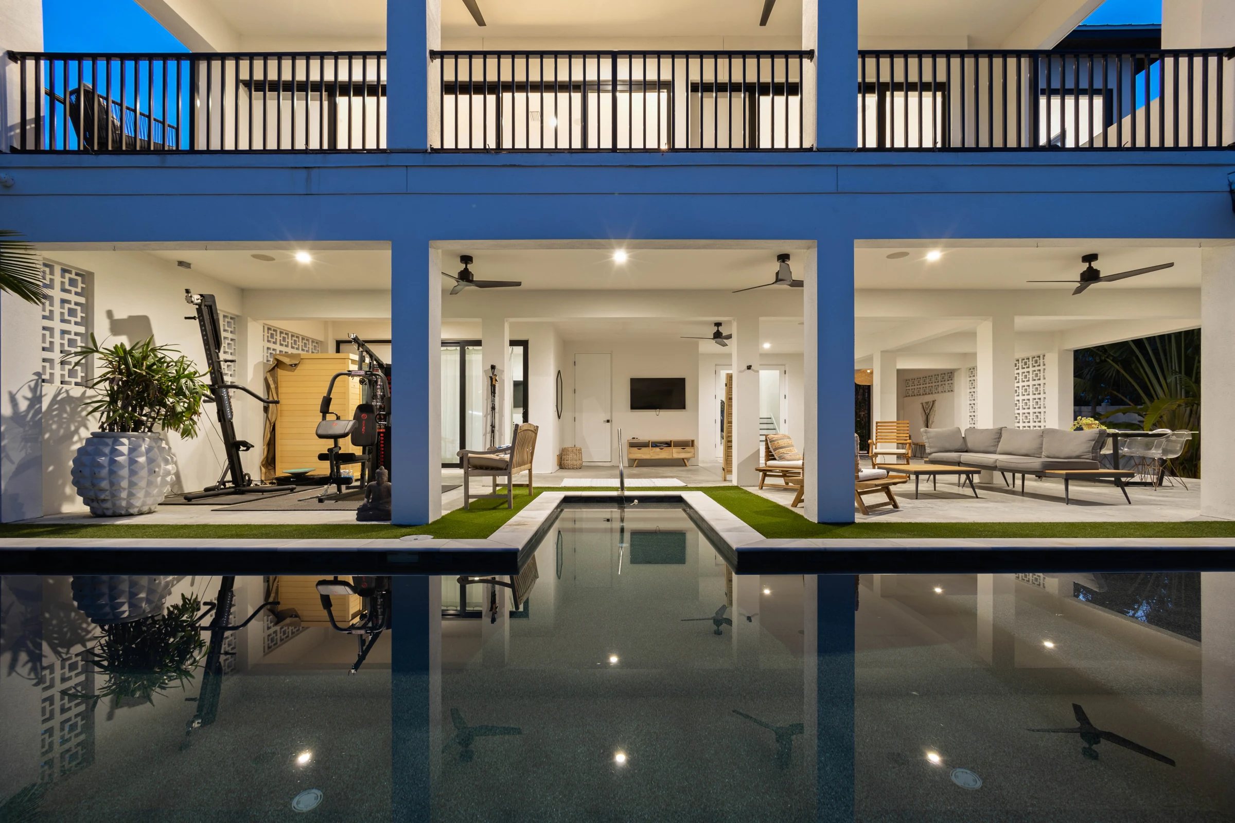 Modern poolside home at blue hour photographed by Vuzario