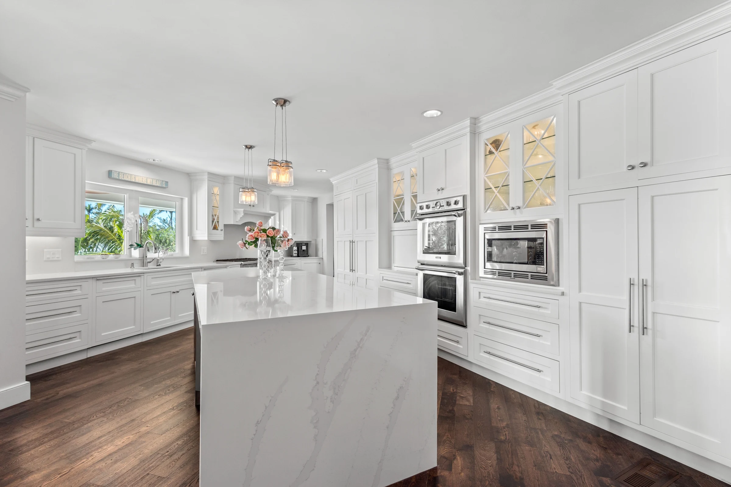 Light-filled kitchen with marble island photographed by Vuzario