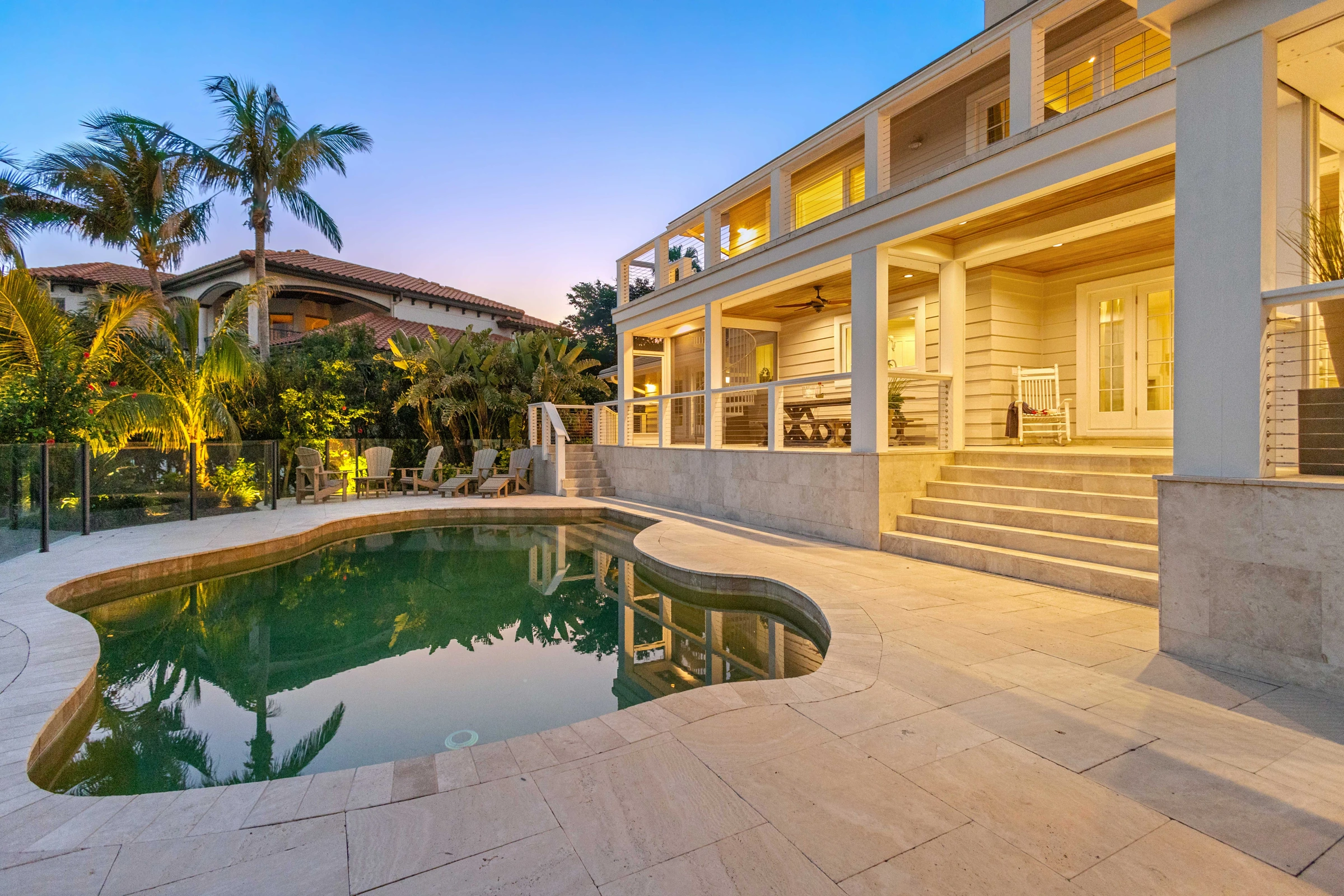 Waterfront home and pool at twilight photographed by Vuzario