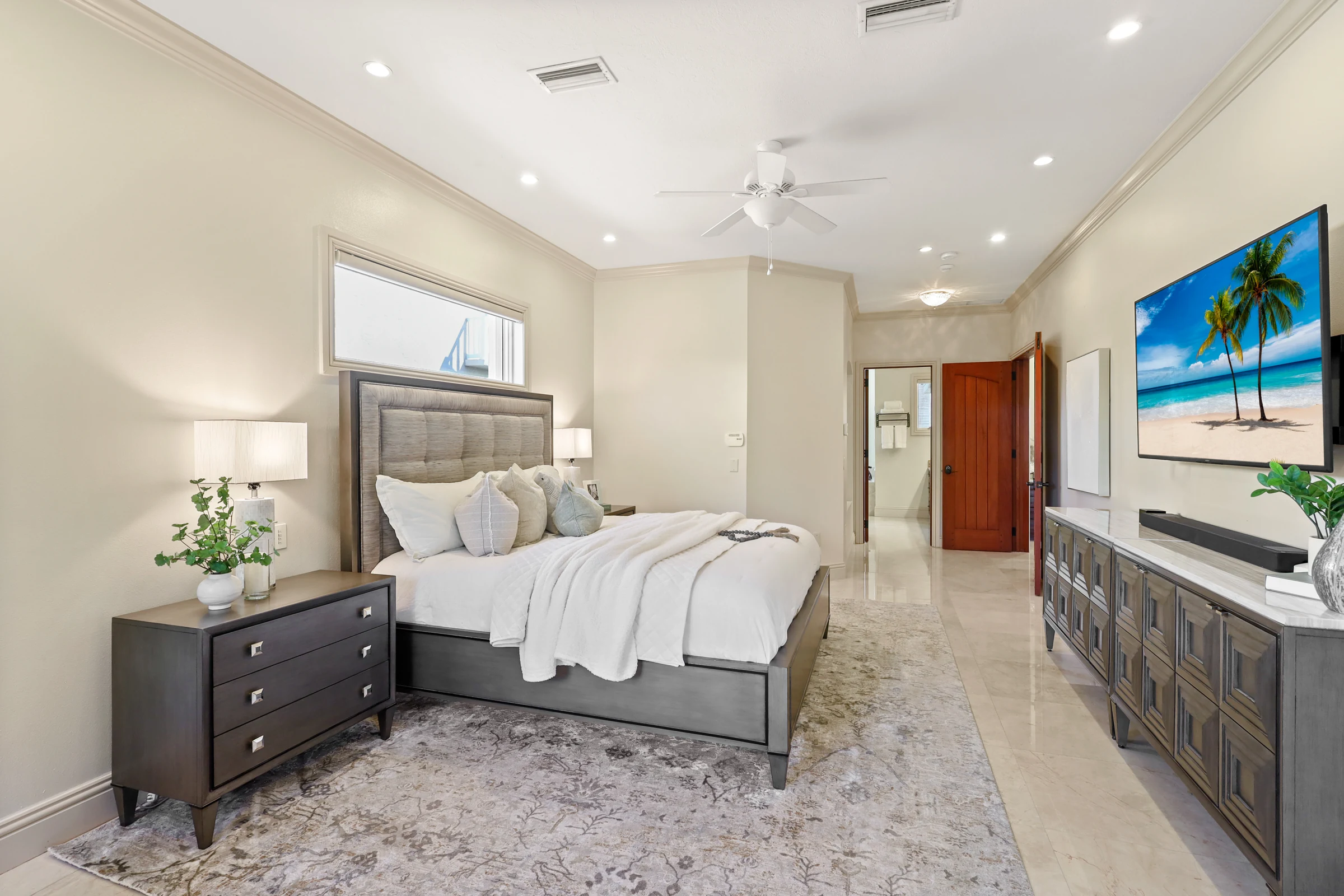 Primary bedroom with tray ceiling photographed by Vuzario