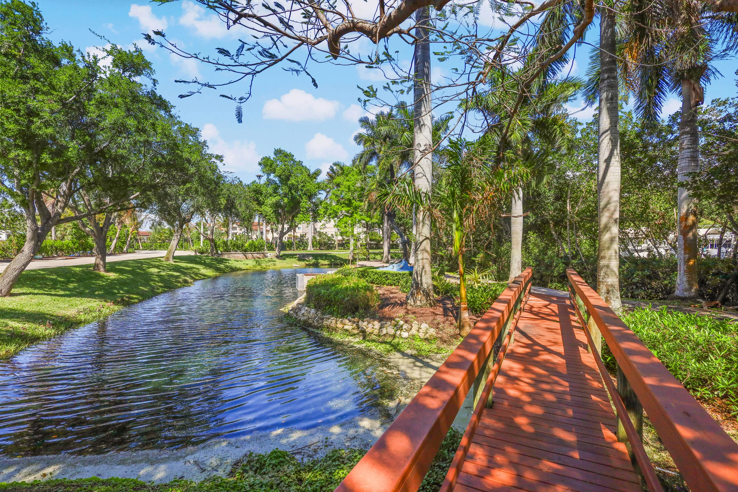 Tree-lined canal and waterfront setting photographed by Vuzario