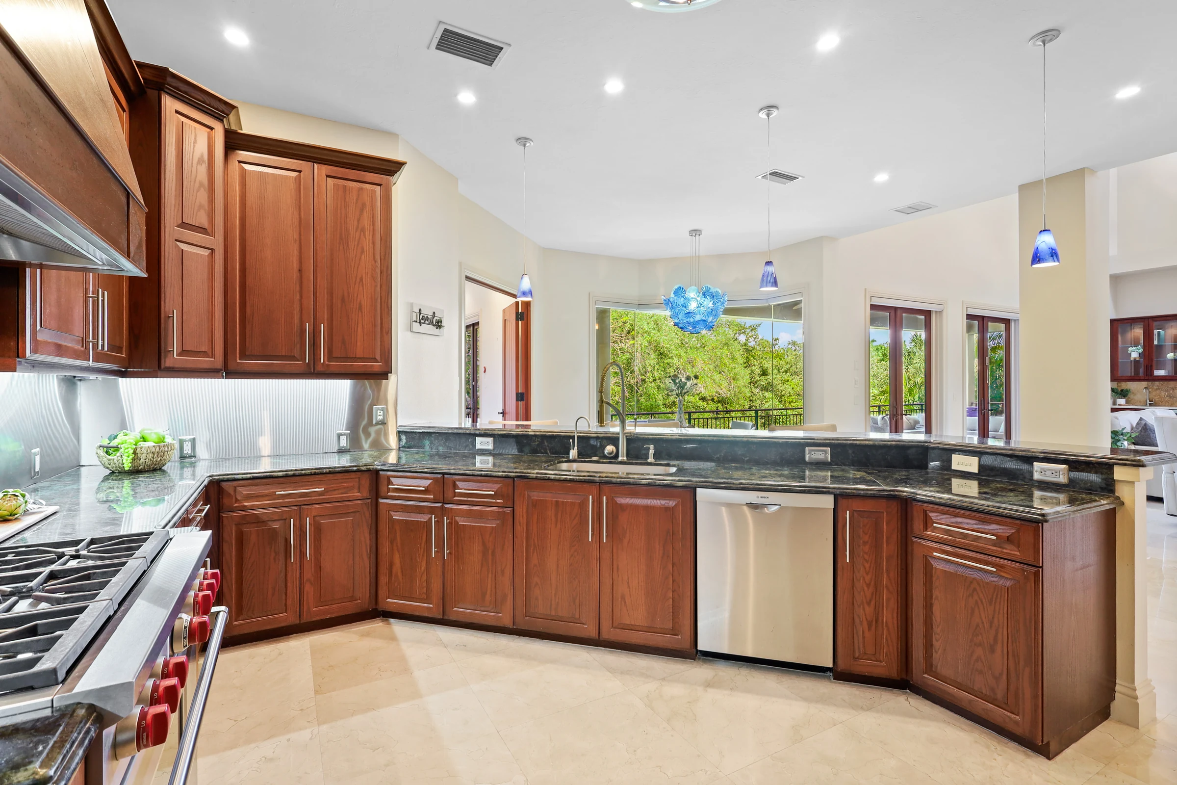 Warm wood kitchen with a large island photographed by Vuzario