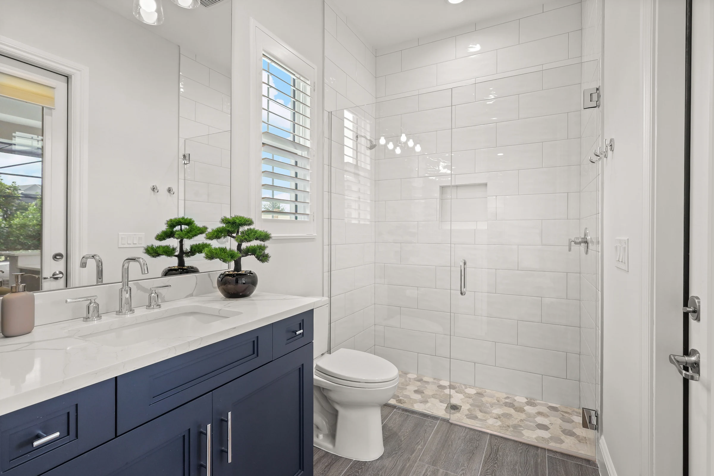 Modern bathroom with navy cabinetry photographed by Vuzario