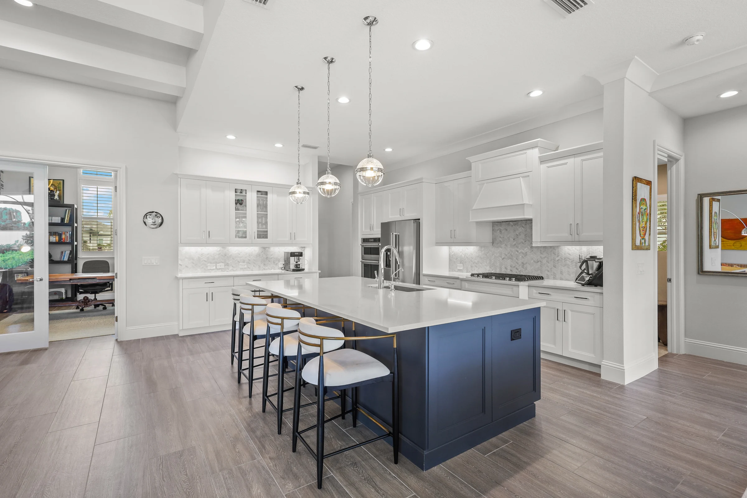 White kitchen with navy island photographed by Vuzario