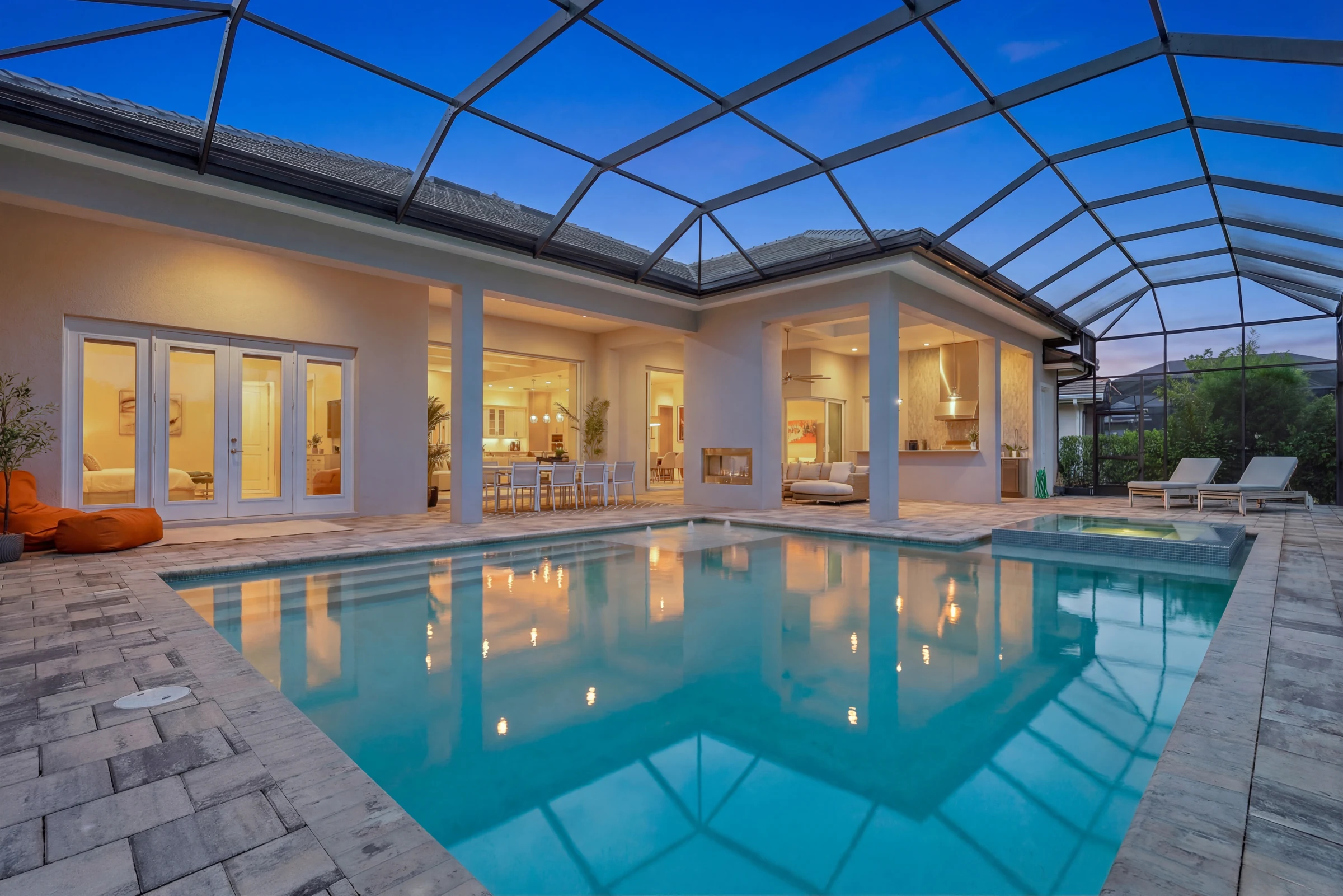Screened pool glowing at blue hour photographed by Vuzario
