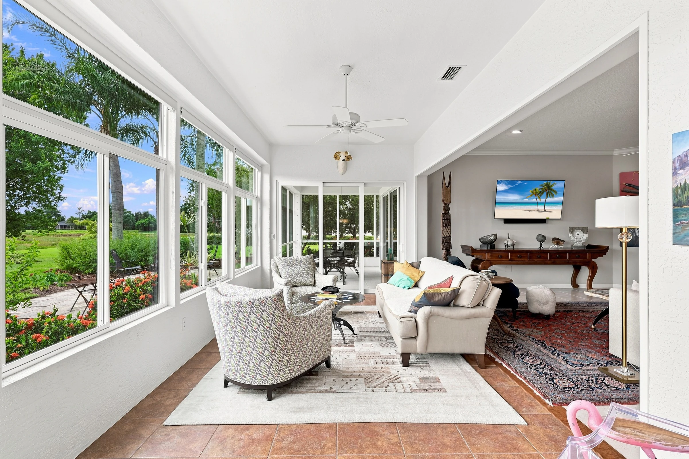 Bright living room with golf-course views photographed by Vuzario